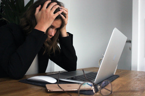 Stressed woman using laptop