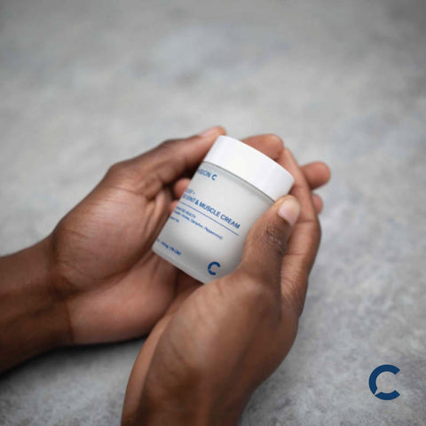 person holding CBD relief cream